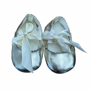 Soft sole gold baby shoes with ribbon tie detail